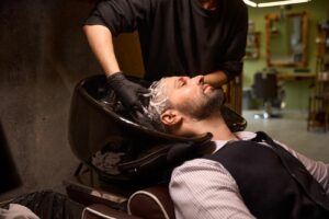 side-view-barber-lathering-adult-man-s-hair-using-2024-07-10-02-08-56-utc.jpg