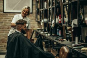 young-bearded-man-getting-haircut-by-hairdresser-2023-11-27-05-00-08-utc.jpg